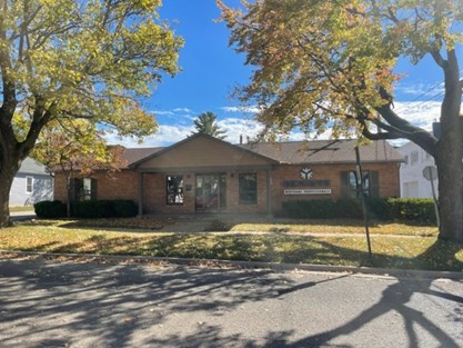 Genisys Mortgage Professionals brick office on a tree-lined street