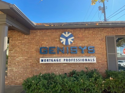 Genisys Mortgage Professionals sign on the brick office building
